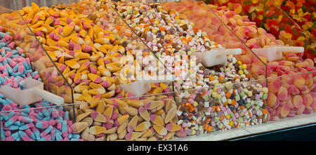 Selection of sweet candies for sale in a pick and mix counter at a sweetshop. A popular method of selling sweets where the custo Stock Photo