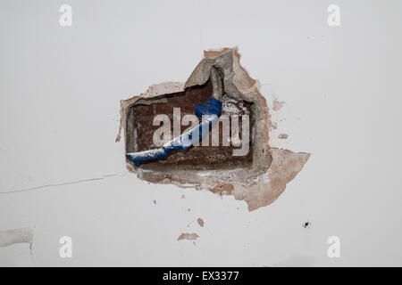cavity in interior wall showing electrical wires covered in insulating tape Stock Photo