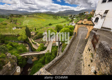 Arch of Felipe V with old Arab bridge and Arab Bath ruins in the city of Ronda Spain Stock Photo