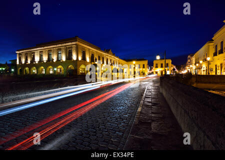 Indigo sky and car lights over Plaza Espana and Puente Nuevo bridge at dusk in Ronda Spain