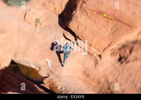 A hiker runs along a trail in the Calico Hills of Red Rock, Nevada, eager to start rock climbing. Stock Photo