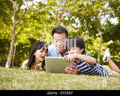 father and children having fun outdoors Stock Photo