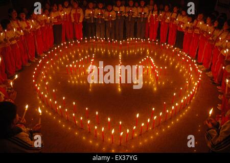 Students light candles to mourn for earthquake victims who died during the magnitude 6.9 earthquake in Yushu of Qinghai province Stock Photo