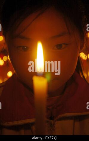 Students light candles to mourn for earthquake victims who died during the magnitude 6.9 earthquake in Yushu of Qinghai province Stock Photo