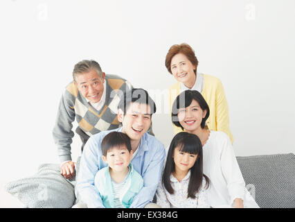 Three-generation Japanese family on the sofa in the living room Stock Photo