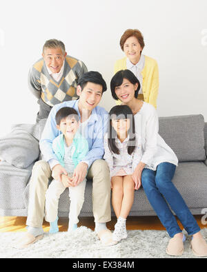 Three-generation Japanese family on the sofa in the living room Stock Photo