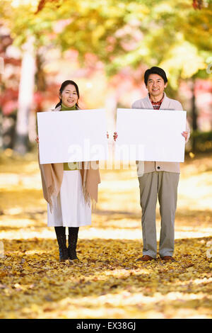 Senior Japanese couple with whiteboard in a city park Stock Photo - Alamy