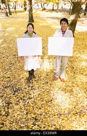 Senior Japanese couple with whiteboard in a city park Stock Photo - Alamy
