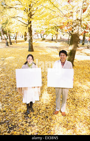 Senior Japanese couple with whiteboard in a city park Stock Photo - Alamy