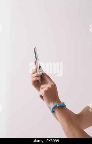 Young Japanese man using smartphone Stock Photo