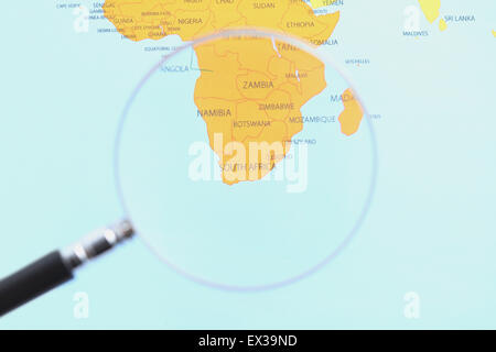 World map and magnifying glass Stock Photo