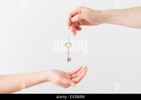 Man and woman hands passing key Stock Photo