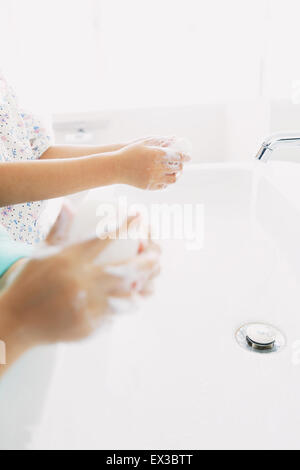 Japanese kids washing hands in the bathroom Stock Photo