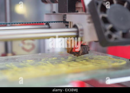 Yellow plastic piece printed in a 3D printer Stock Photo