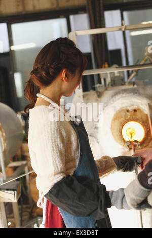 Young Japanese woman enjoying glass crafting workshop in Kawagoe, Japan Stock Photo