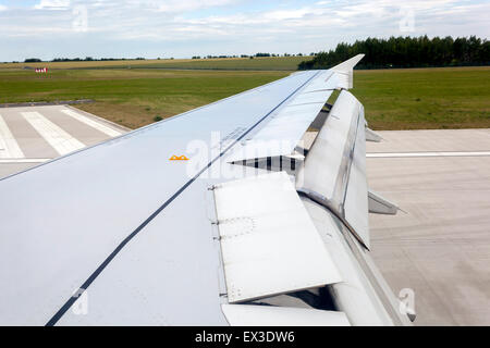 A320 Airbus Wing flaps aircraft landing on runway Plane landed Prague, Czech Republic Stock Photo