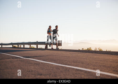 woman jogging on a country road through the beautiful sunny forest,  exercise and fitness concept Stock Photo - Alamy