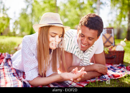 Happy young couple relaxing in park on weekend Stock Photo