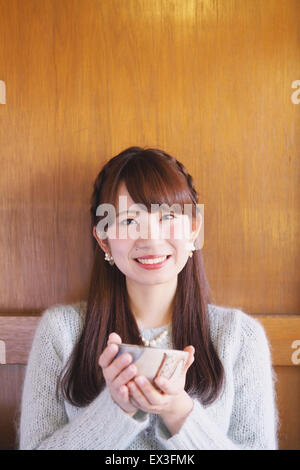 Young Japanese woman enjoying Maccha green tea in Kawagoe, Japan Stock Photo