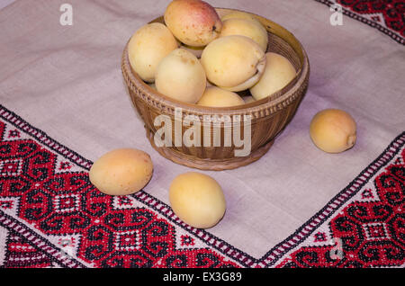 Ripe apricots in a woven basket Stock Photo