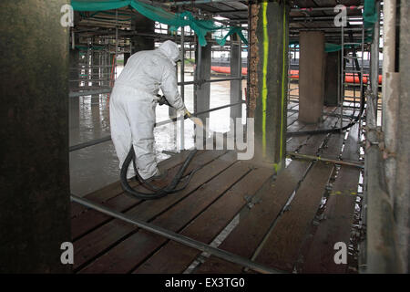 A contractor uses sprayed concrete to repair the support structure below the Woolwich Ferry vehicle loading ramp Stock Photo