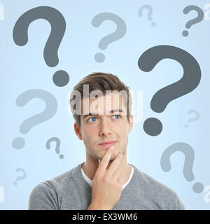 young man with question marks Stock Photo