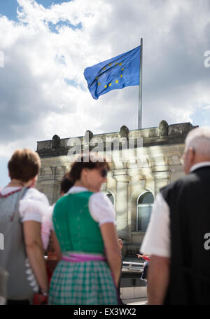 Berlin, Germany. 06th July, 2015. A flag of the European Union flies on the rooftop of the Reichstag, the German parliamentary building, with dark clouds hovering above it, in Berlin, Germany, 06 July 2015. Photo: Bernd von Jutrczenka/dpa/Alamy Live News Stock Photo