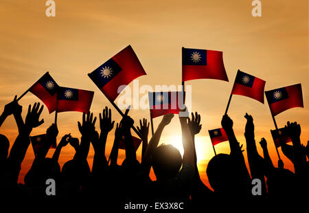 Group of People Waving Taiwanese Flags in Back Lit Stock Photo