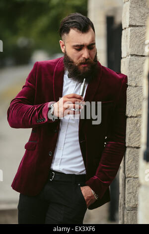 rich man in a jacket near his house Stock Photo