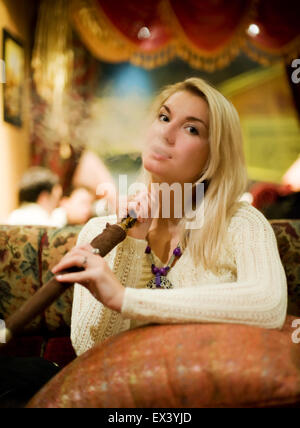 Beautiful young woman with hookah Stock Photo