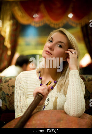 Beautiful young woman with hookah Stock Photo