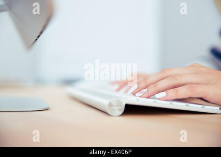 Closeup portrait of a female hands using keyboard Stock Photo