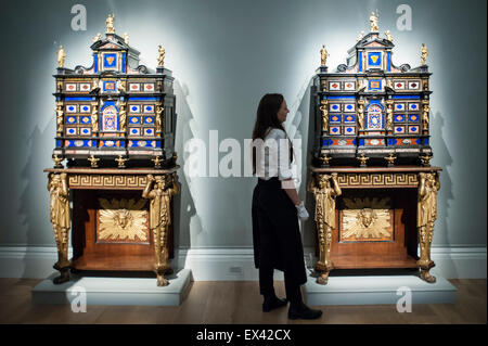 London, UK.  6 July 2015. A Sotheby's technician shows a pair of Italian pietre dure mounted, inlaid ebony cabinets (est. £800k to £1.2m)  at the preview of Old Masters, British Paintings and Masterworks from the collection of Castle Howard at Sotheby's ahead of the auction on July 8. Credit:  Stephen Chung / Alamy Live News Stock Photo