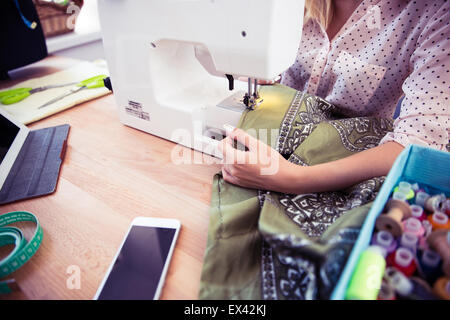 Closeup portrait of a woman using a sewing machine Stock Photo