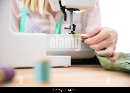 Closeup portrait of a woman using a sewing machine Stock Photo