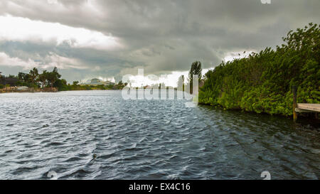 Dark clouds hovering over the water before a heavy storm in Cape Coral, Florida Stock Photo