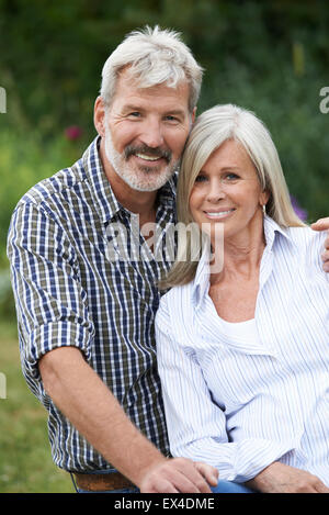 Portrait Of Mature Couple Relaxing In Garden Together Stock Photo