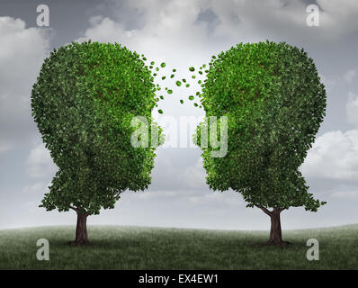 Communication and growth concept as a growing partnership and teamwork exchange in business with two trees in the shape of human heads on a sky with leaves exchanging from one face to the other as a concept of cooperation. Stock Photo