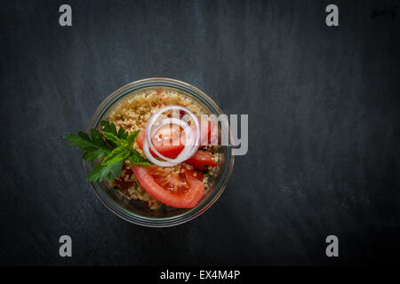 Couscous in jar on slate background. Top view Stock Photo