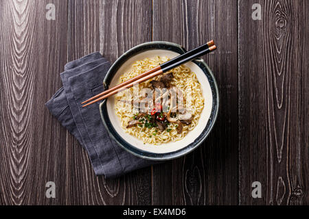 Asian noodles with Oyster mushrooms in bowl on gray wooden background