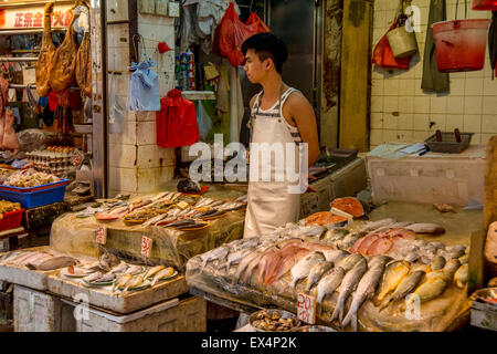 A merchant is waiting for customers at the food market in Hong-Kong, China Stock Photo