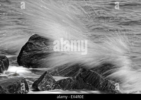 Waves splashing on rocks Stock Photo