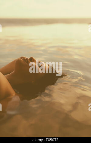Young Woman Floating in Water