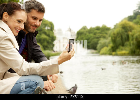 Smiling Couple Taking Selfie, St. James's Park Lake, London, England