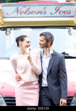 Smiling Couple Standing in front of Ice cream Van