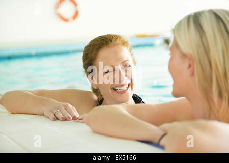 Two Women in Indoor Swimming Pool Smiling