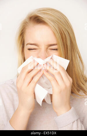 Young Woman Blowing her Nose Sneezing