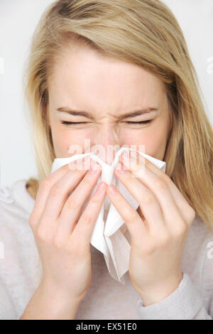 Young Woman Blowing her Nose Sneezing
