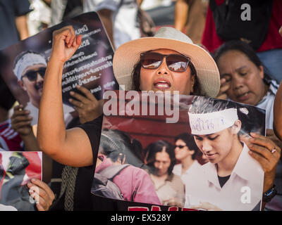 Bangkok, Thailand. 07th July, 2015. Activists a rally at the Ministry of Defense and hold photos of the 14 students arrested by the military. About 100 people gathered in front of the Ministry of Defense in Bangkok Tuesday to support 14 university students arrested two weeks ago for violating orders against political assembly. They're facing criminal trial in military courts. The courts ordered their release Tuesday because they can only be held for two weeks without trial, the two weeks expired Tuesday and the military court chose not to renew their pretrial detention. © ZUMA Press, Inc./Alam Stock Photo