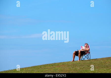man relaxing in portable seat Stock Photo